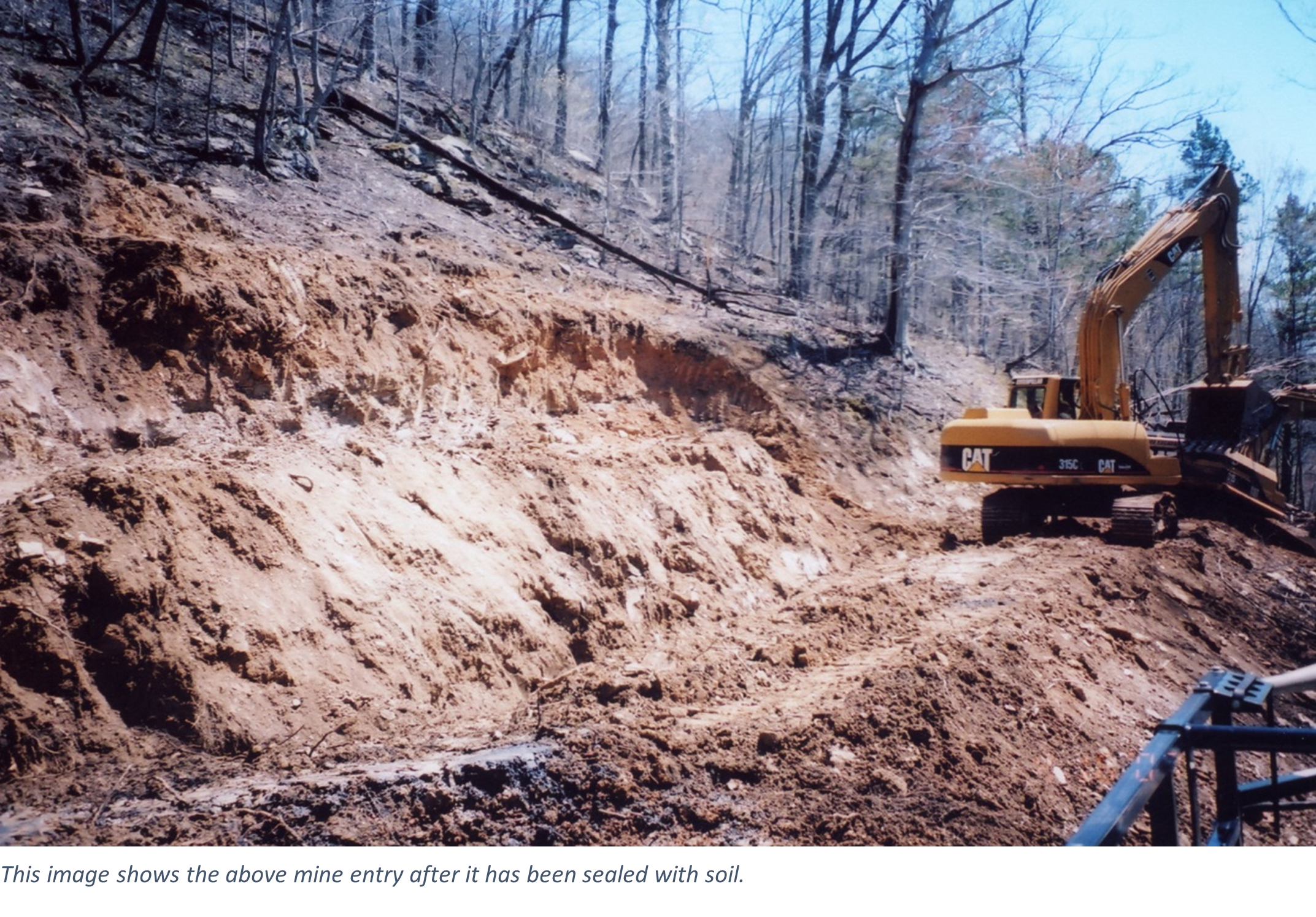 This image shows the above mine entry after it has been sealed with soil.