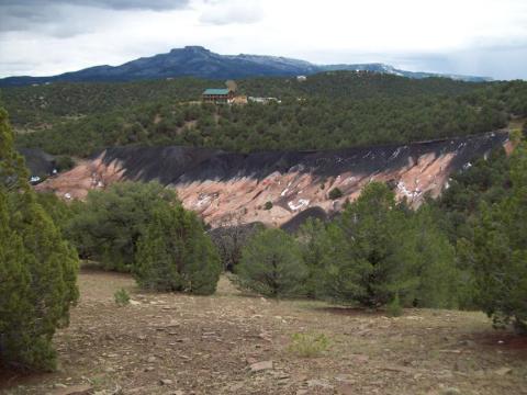 Trees and and old coal seam are seen across a hilly landscape photo of the West Sopris coal refuse reclamation project, Las Animas County, Colorado