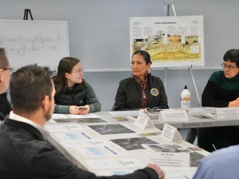 Secretary Haaland sits at a table with OSMRE and PA officials